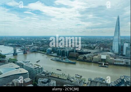 Aerial shot of London with the River Thames, Shard, Tower Bridge, City Hall, HMS Belfast, and London Bridge Station, etc.