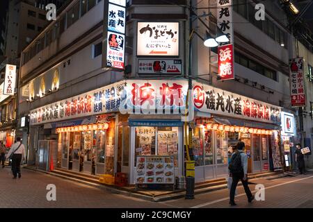 Ueno, Japan- July 30, 2020: A restaurant stands open, during the night, in Akihabara. Stock Photo