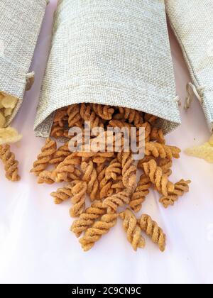 Spicy fried pasta wheat snack in a brown bag Stock Photo