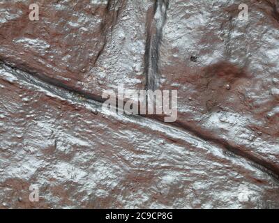 Old stone wall with metallic silver paint as texture, background Stock Photo