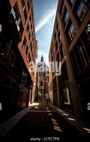 St Pauls seen through alley of red brick shops Stock Photo