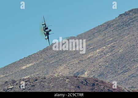 Massachusetts Air National Guard F-15C Eagle Diving Into Rainbow Canyon, California, USA. Stock Photo