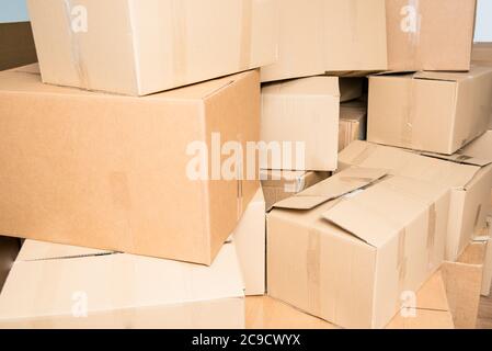 Detail of many cardboard boxes full of household items during a move. Stock Photo