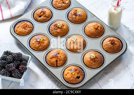 Freshly  baked blackberry and almond friands - small cakes, popular in Australia and New Zealand Stock Photo