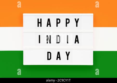 HAPPY INDIA DAY written in a lightbox on a background of Indian flag color. Independence day date. Top view. Stock Photo