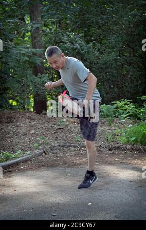 A man plays Jianzi, a traditional Chinese sport in which players aim to keep a heavily weighted shuttlecock in the air by using their bodies.. Stock Photo