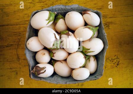 Container of white baby eggplants Stock Photo