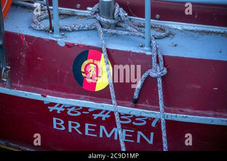 21 May 2020, Mecklenburg-Western Pomerania, Gager: A GDR flag is stuck on a sailboat in the small harbour. Photo: Jens Büttner/dpa-Zentralbild/ZB Stock Photo