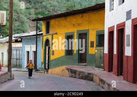 Batopilas, Chihuahua, Mexico.  Early Morning Street Scene, Young Girl Walking to School. Stock Photo