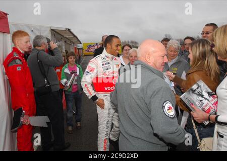 A young Williams F1 driver George Russell, possibly seeking Lewis Hamilton's autograph in 2009. Stock Photo