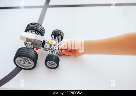 Schoolgirl holding constructor robot in robotics class Stock Photo