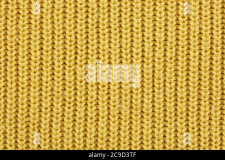 Yellow knitted ribbed wool textile background texture Stock Photo