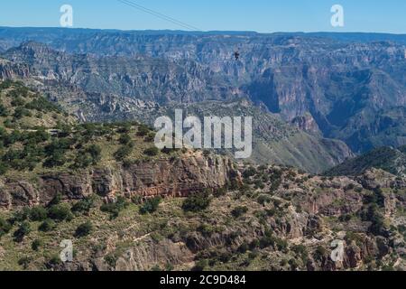 Ziplining at Divisadero, Copper Canyon, Chihuahua, Mexico. 8350 feet long, longest zip line in the world.  Speed may reach 70 mph on the descent. View Stock Photo
