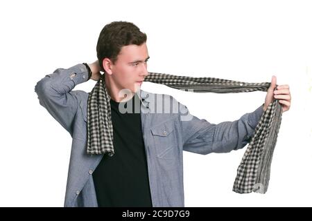A young man in a Manatee shirt, black t-shirt and trousers, isolated on white. dresses, ties a checkered scarf Stock Photo