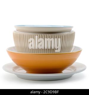 Stack of different bowls and plates on white background Stock Photo