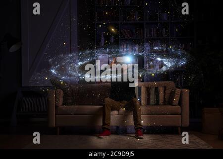 Man uses virtual reality glasses to see the galaxy space. Elements of this image furnished by NASA. Stock Photo
