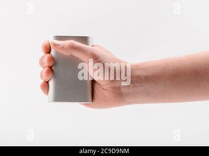 Hand holding a power bank, isolated on white Stock Photo