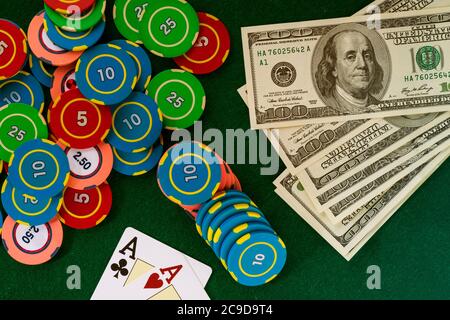 Deck cards on casino table with betting chips and money in American dollars Stock Photo
