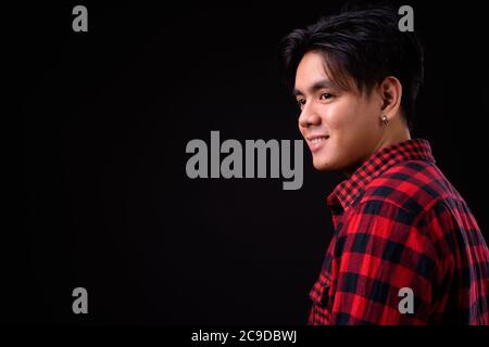 Portrait of happy young handsome Asian hipster man Stock Photo