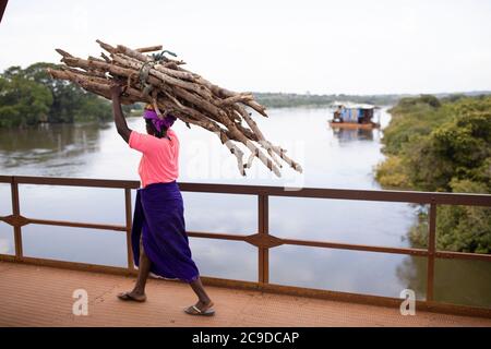 Residents traverse a bridge over the Niger River, Africa’s third longest, in Kouroussa, Guinea. Catholic Relief Services - Guinea. October 14, 2018. Photo by Jake Lyell. Stock Photo