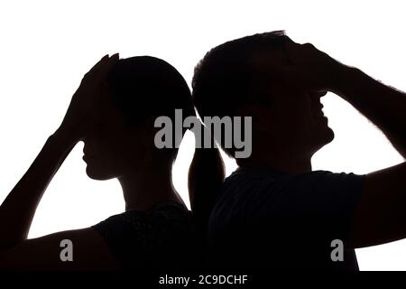 Faces women and men across from, brother and sister - silhouette Stock Photo