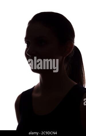 Young woman look ahead with flowing hair - vertical, isolated silhouette of a front view Stock Photo