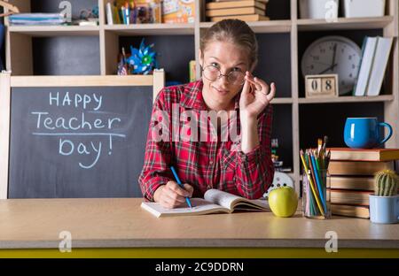 Formal education. Teacher pretty woman enjoy educational process in classroom. Teachers day.  (Soft focus on girl) Stock Photo