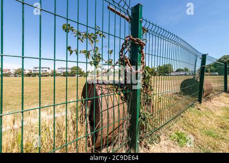 Chalkwell Park in Westcliff on Sea, Southend, Essex, UK. Southend on Sea Borough Council green space in an urban area.Cricket pitch rollers chained up Stock Photo