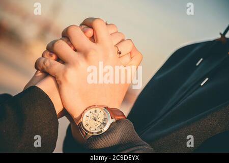 Man holding woman's hands with engagement ring and making propos Stock Photo