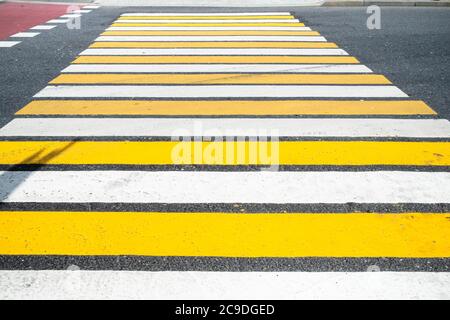 surface of urban road with yellow and white zebra pedestrian crossing on Nikitskiye Vorota square in Moscow city Stock Photo