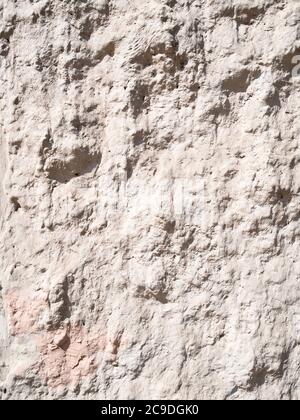 rough plastered outdoor wall lit by sun in sunny day Stock Photo