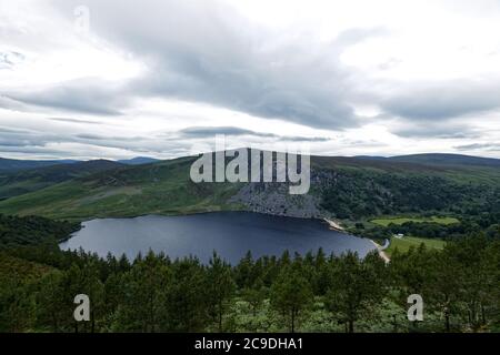 Lough Tay in Wicklow mounts.The place of filming early episodes Vikings series.The film attribute vikings drakkar boat still  moored at the lake shore Stock Photo