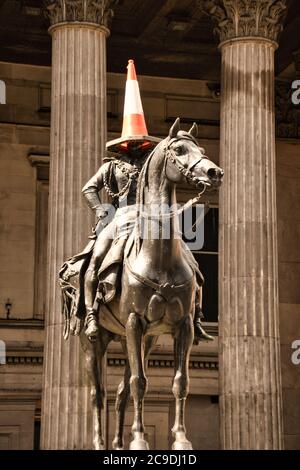 Marochetti's Duke of Wellington statue stands outside Glasgow's Museum of Modern Art in Royal Exchange Square with locally added traffic cones. Stock Photo