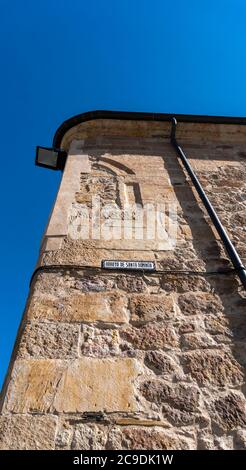 Ceramic street sign on an ancient building in the city of Salamanca, Spain, translation is Stream of Saint Domingo Stock Photo