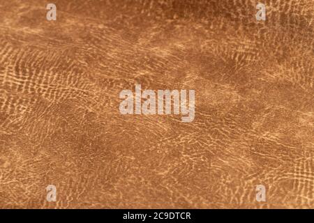 brown faux suede leather for the concept and style idea of fine leather craft, handmade work space. Background textures and Wallpapers. Stock Photo