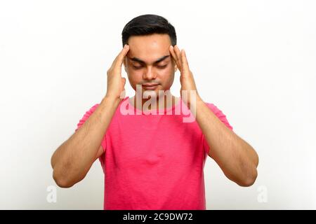 Portrait of young handsome Indian man against white background Stock Photo