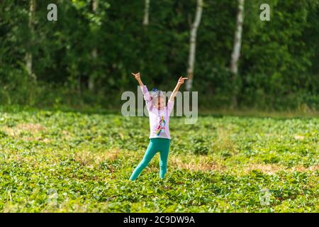 Little girl posing in strawberry field in Sevenoaks, Kent Stock Photo