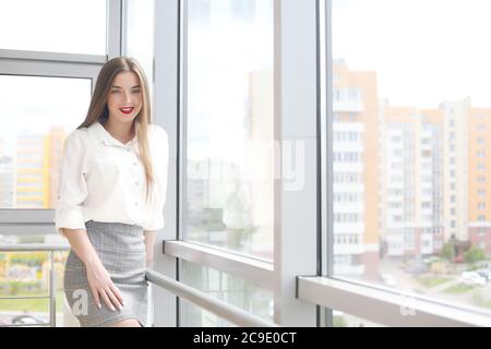 young female student sitting in the office solving problems Stock Photo
