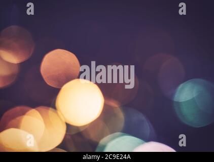 Christmas garland defocused. Yellow blue bokeh on dark with copyspace. Stock Photo