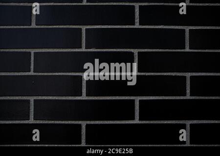 Detail of a black brick wall with the lines between the bricks very marked. Empty background for copy space Stock Photo