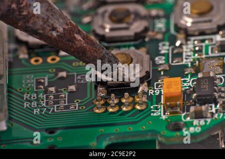 soldering iron on circuit board assembly. Electronic components Stock Photo