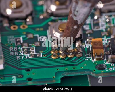 soldering iron on circuit board assembly. Electronic components Stock Photo