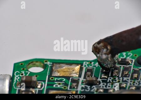 soldering iron on circuit board assembly. Electronic components Stock Photo