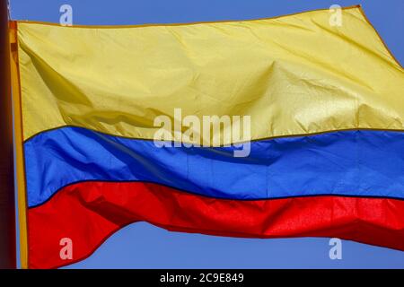 colombian flag , blowing in the wind with blue sky on background Stock Photo