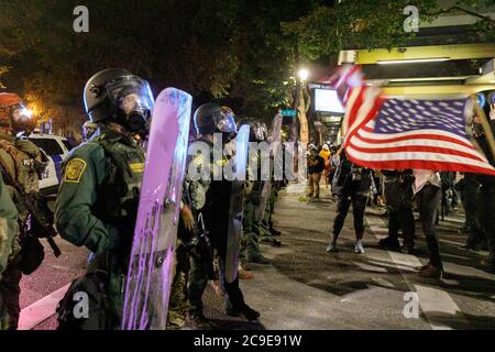 Portland, USA. 30th July, 2020. Five hundred protesters rallied outside the Hatfield Federal Courthouse in Portland, Oregon on the night of July 29, 2020 for the 63rd consecutive night, protesting the presence of Federal officers in the city, and continuing the Black Lives Matter protests. Federal agents deployed tear gas and less-lethal munitions at about 11 pm. © John Rudoff 2020 Credit: Sipa USA/Alamy Live News Stock Photo