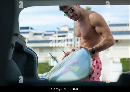 Muscle man surf board Stock Photo