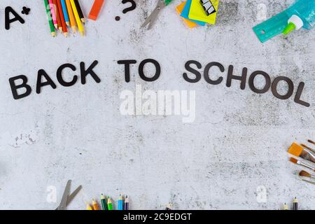 Background of school supplies with text back to school. Top view. Stock Photo