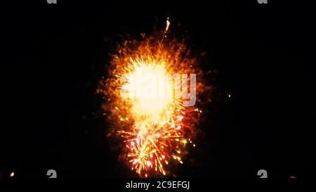 Close up isolated image of a firework show as multiple fireworks explode at the same time. Image features a colorful scene on dark night sky backgroun Stock Photo