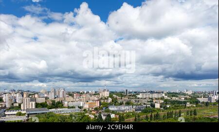 Large gray and white clouds loomed over Kyiv's residential areas, green parks and a television tower. Stock Photo