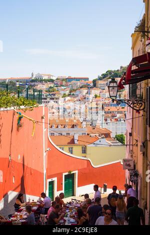 LISBON, PORTUGAL - SEPTEMBER 13, 2019: Outdoor cafe on the old streets of Alfama, overlooking Baixa Stock Photo